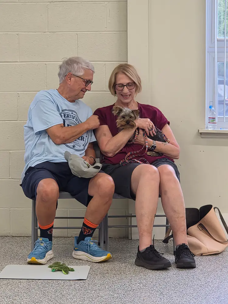 Couple with dog getting ready for training